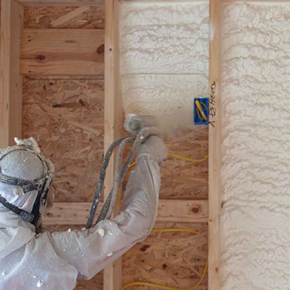Closed-cell spray foam being applied to attic walls — energy-efficient insulation in Green Bay