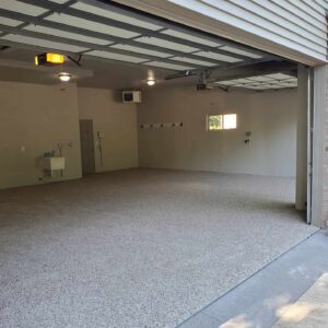 Epoxy-coated garage floor with beige flake finish and clean interior walls