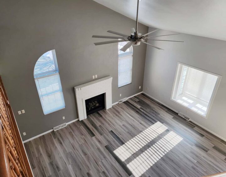 Residential living room with luxury vinyl plank flooring and vaulted ceilings