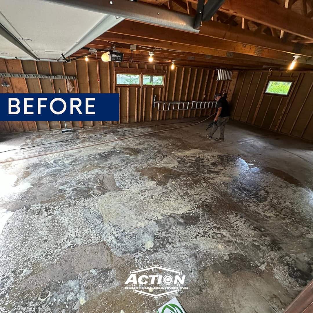 Damaged and stained concrete garage floor before epoxy coating installation by Action Painting & Epoxy Coatings in Northeast Wisconsin